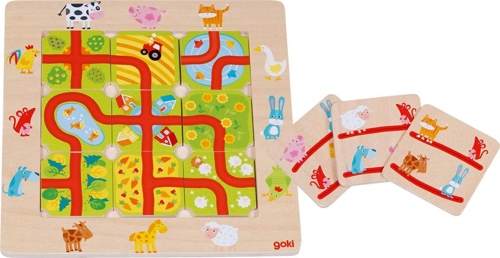Gioco in legno Goki Trova la strada nel Paese con animali della fattoria, percorsi e carte sfida.
