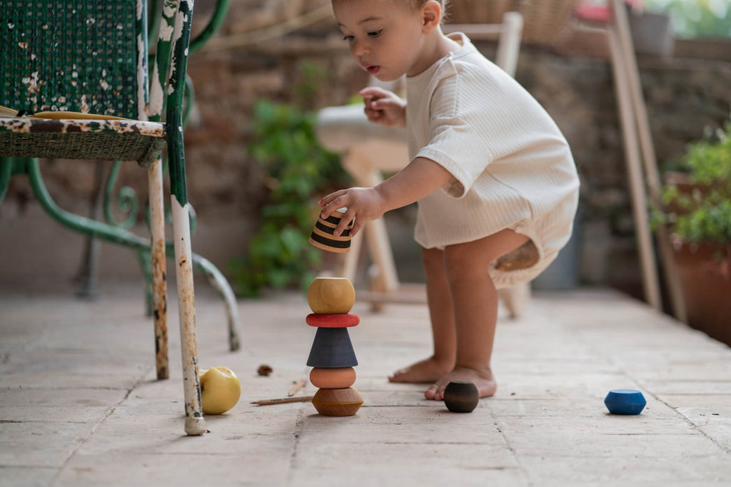 Bambino che impila i pezzi del Grapat Serendipity, gioco libero di equilibrio e scoperta